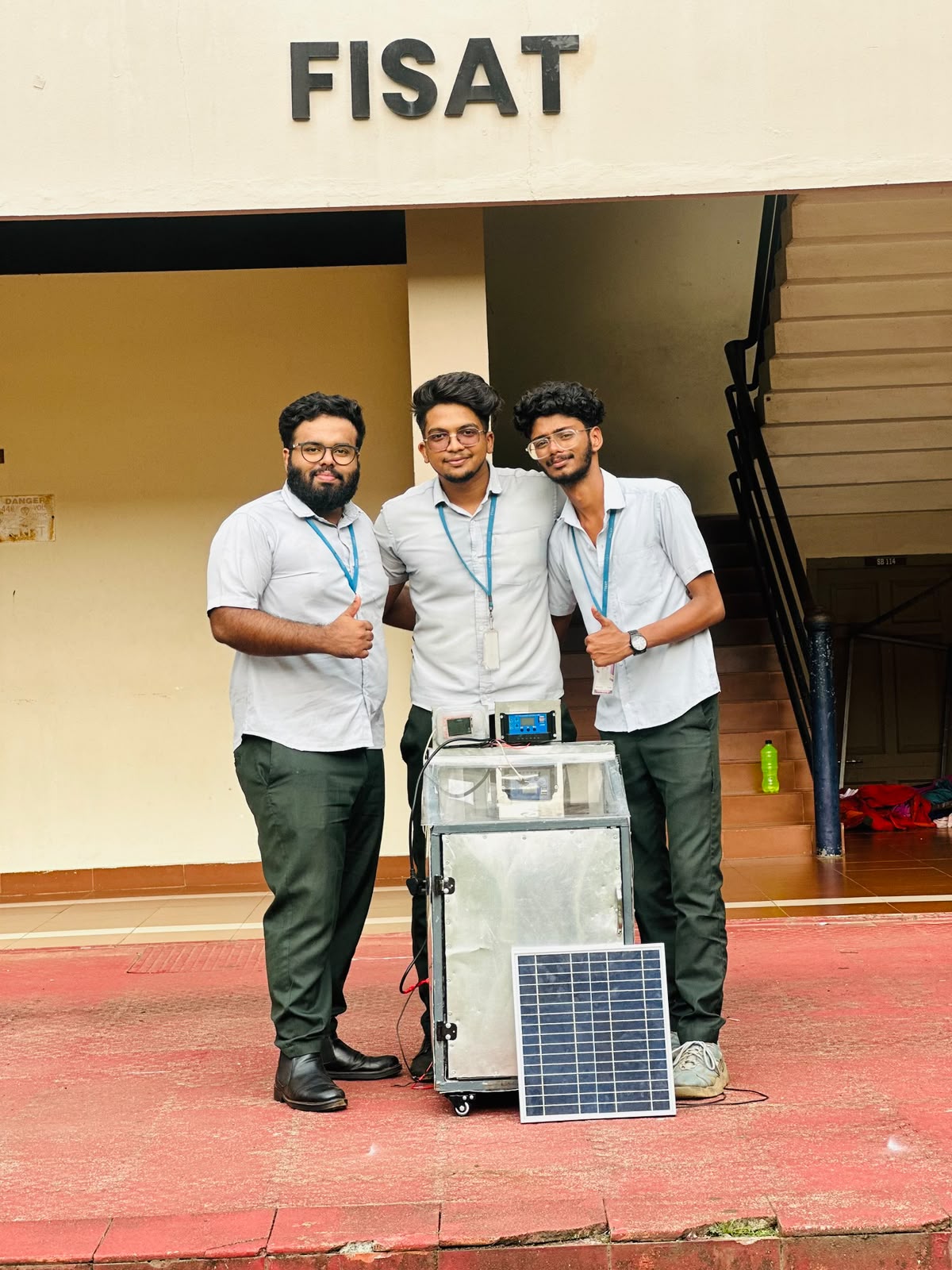 Student team presenting their solar dryer project at FISAT
